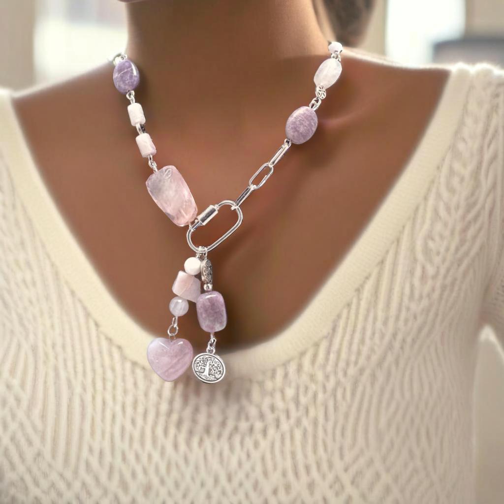 Bold 18-inch silver necklace featuring rose quartz, amethyst, and pink opal stones in an asymmetrical design. Dangled charms include a rose quartz heart with pink opal and an amethyst paired with a Tree of Life charm. A timeless, modern accessory perfect for day-to-night wear.