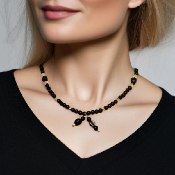 A handcrafted 18-inch black agate necklace featuring a stylish front-tie detail and a signature handmade hook clasp. Designed for versatility, this elegant piece is believed to dispel negative energy while promoting happiness and harmony. A timeless accessory by Lacey & Bohème, perfect for any occasion. Handmade in Canada.