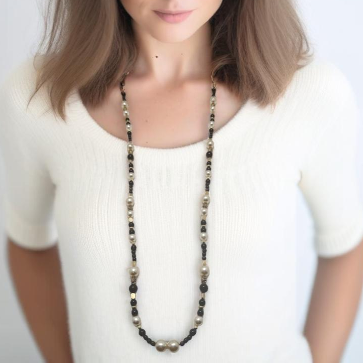A sophisticated 39-inch handcrafted necklace featuring luminous pearls and sleek black agate beads, accented with gold-plated details for a refined touch. Designed for effortless day-to-night elegance, this versatile piece is finished with a unique handmade hook clasp. A timeless addition to any jewelry collection, crafted with care by Lacey & Bohème. Made in Canada.