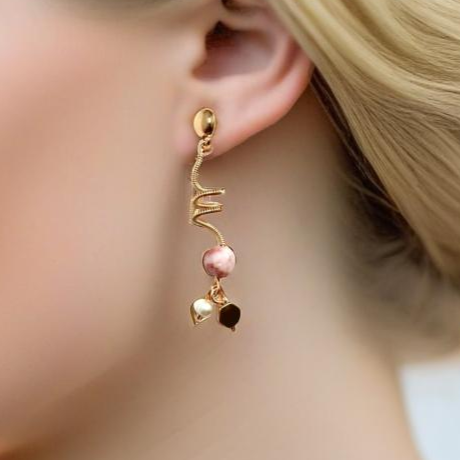 Gold-tone pierced stud earrings featuring a wrapped wire spiral design, accented with a lustrous pearl and sleek gold-tone hexagon charm. A lightweight, versatile blend of classic sophistication and modern elegance.