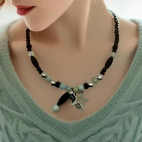 A handcrafted 18-inch necklace featuring a mix of black jasper, aquamarine, and aluminum beads, accented with a charming star pendant. Finished with a signature handmade hook clasp, this unique piece blends natural stones with modern materials for a versatile, stylish look. Handmade with care by Lacey & Bohème in Canada.