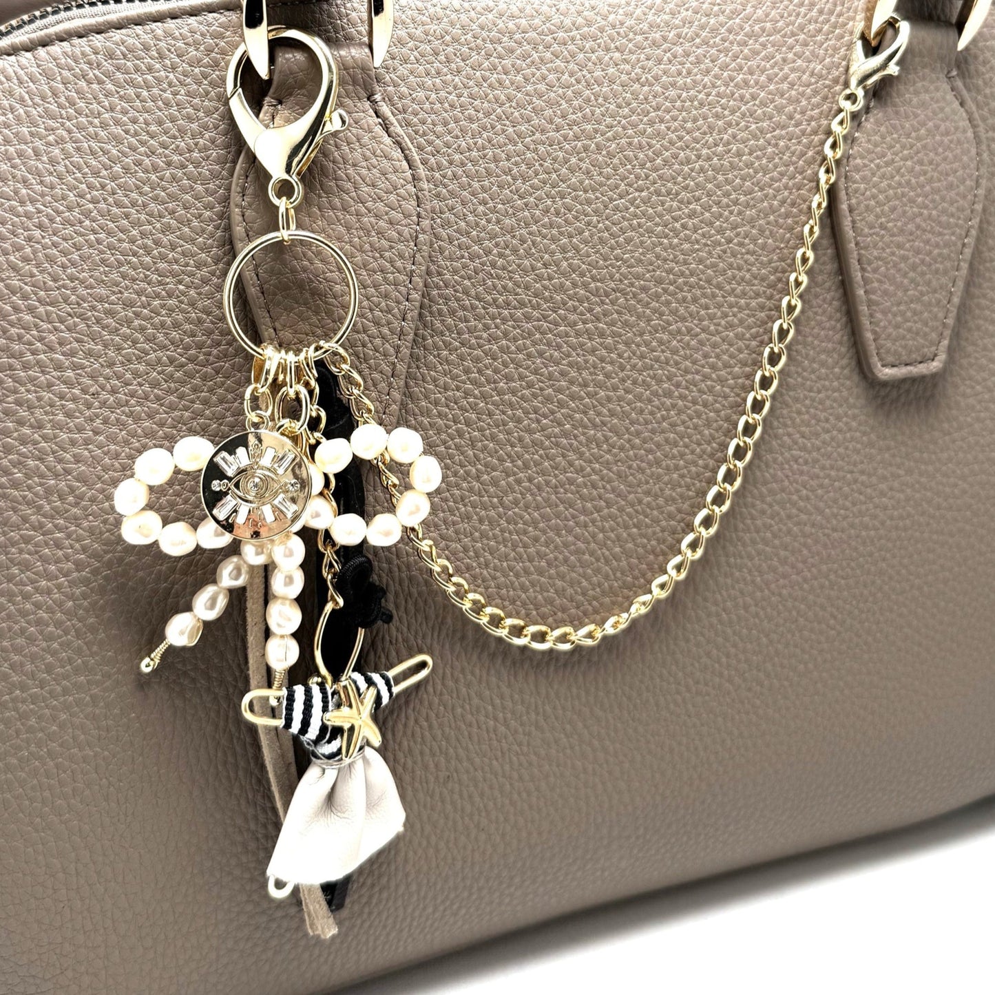 Handmade Boheme Purse Charm with a pearl bow, Pixie figurine, gold chain, leather tassels, and a gold charm, perfect for accessorizing bags, jeans, or belt loops.