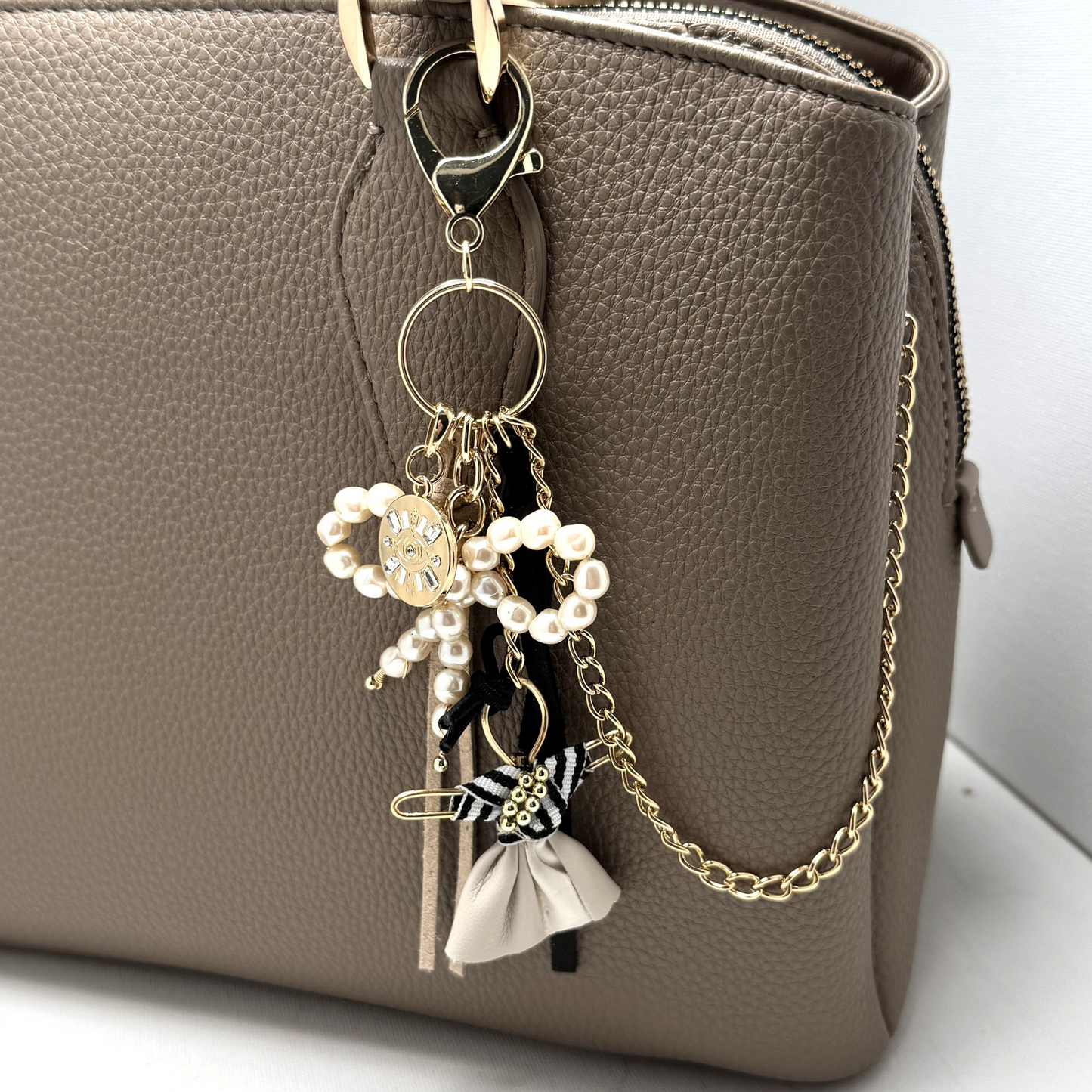 Handmade Bohème Purse Charm with a pearl bow, Pixie figurine, gold chain, leather tassels, and a gold charm, perfect for accessorizing bags, jeans, or belt loops.