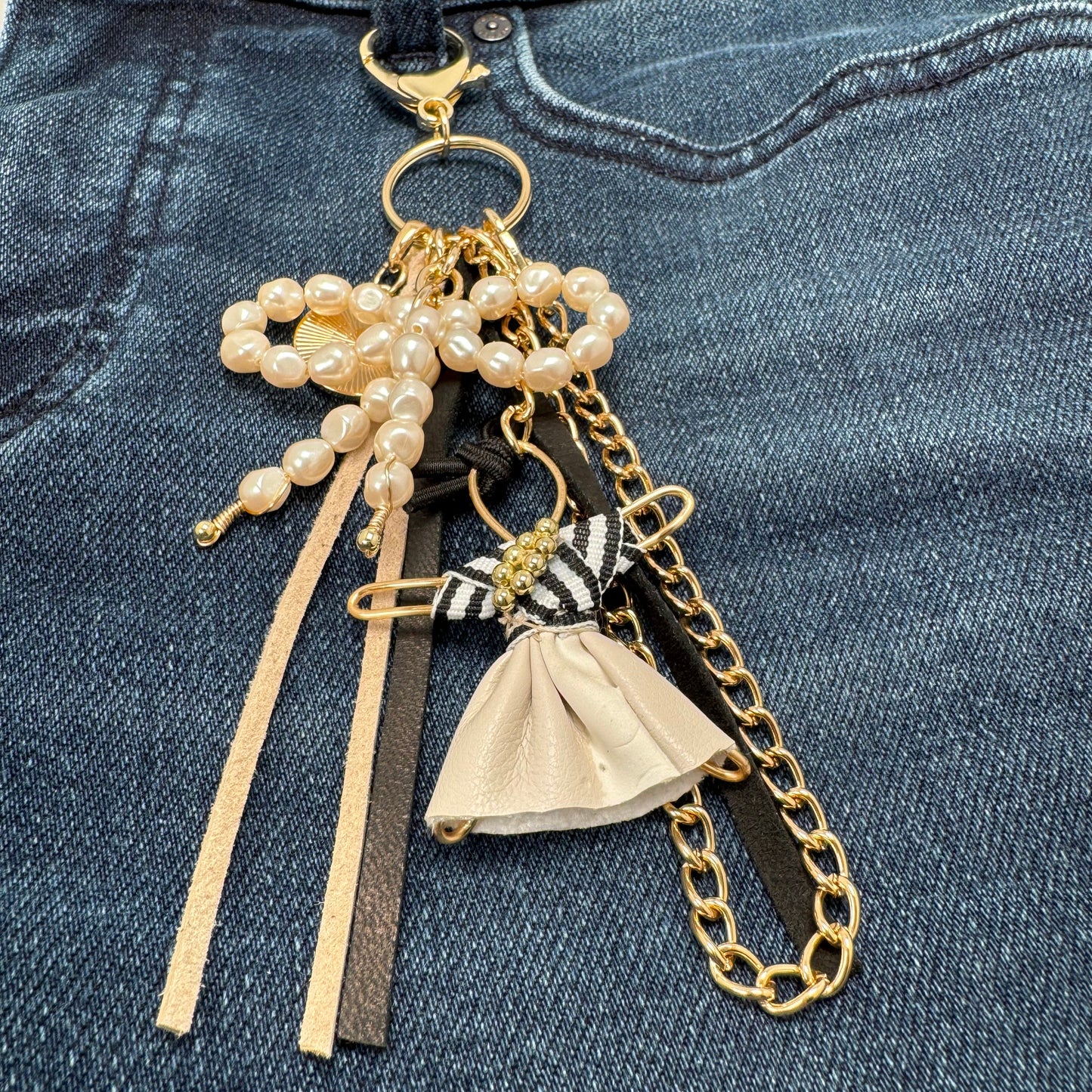 Handmade Bohème Purse Charm with a pearl bow, Pixie figurine, gold chain, leather tassels, and a gold charm, perfect for accessorizing bags, jeans, or belt loops.