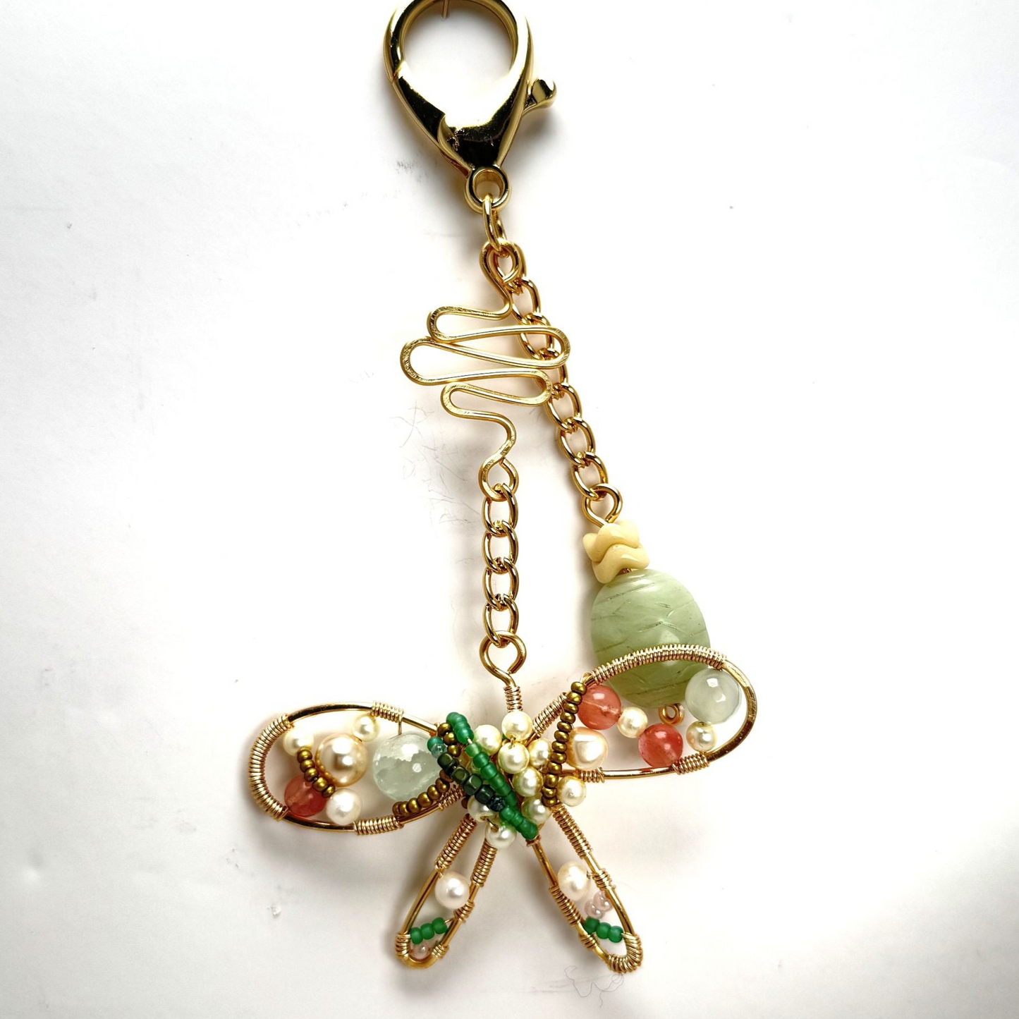 Handmade stylized butterfly purse charm with forged wire, glass, and vintage beads, clipped to a handbag with lobster clasp.
