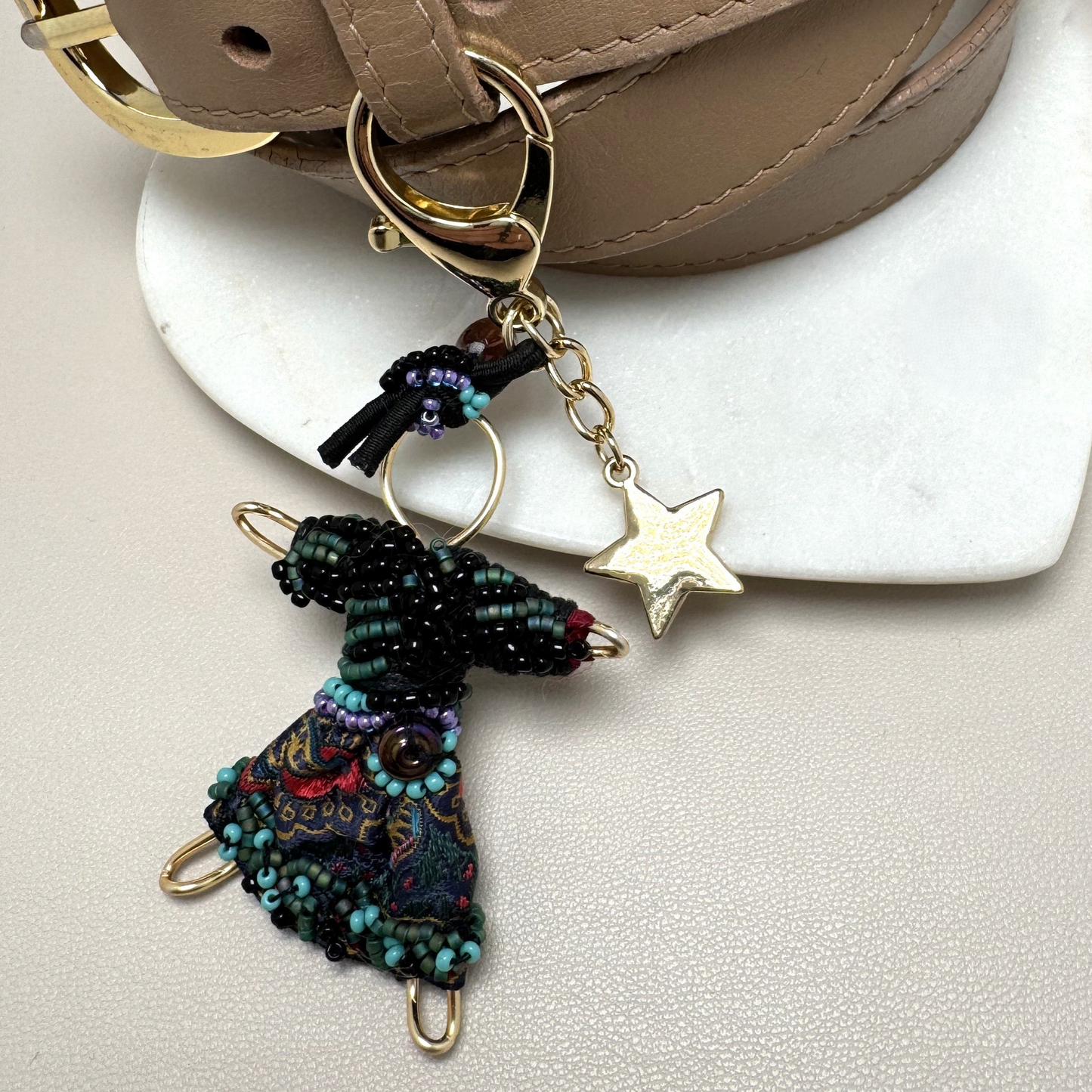 pixie purse charm with silk skirt and gold star accent.