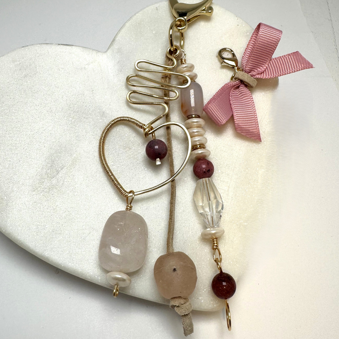 Handmade purse charm with rose quartz, sea glass, rhodonite, faux pearl, and a hand-forged wire-wrapped heart pendant.
