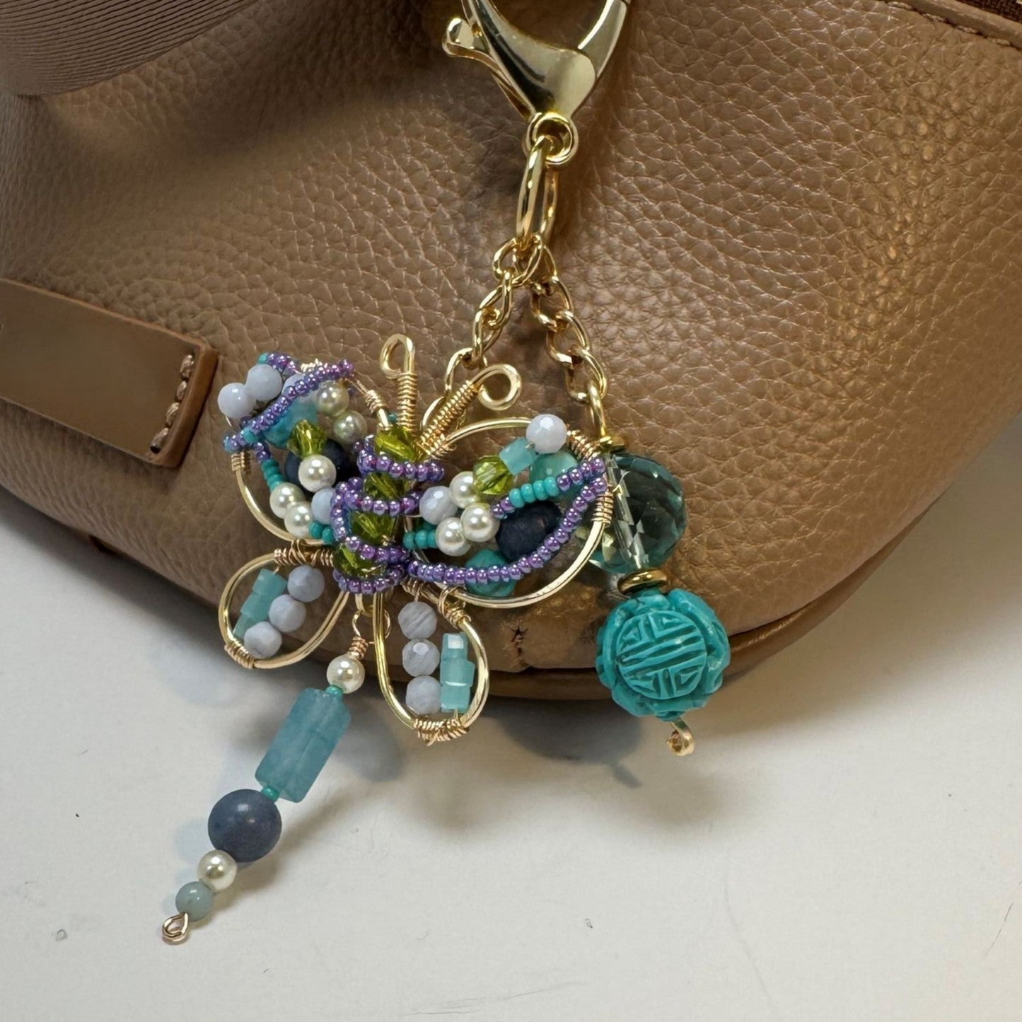 Handmade butterfly purse charm with semi-precious stones and wire wrapping, symbolizing transformation