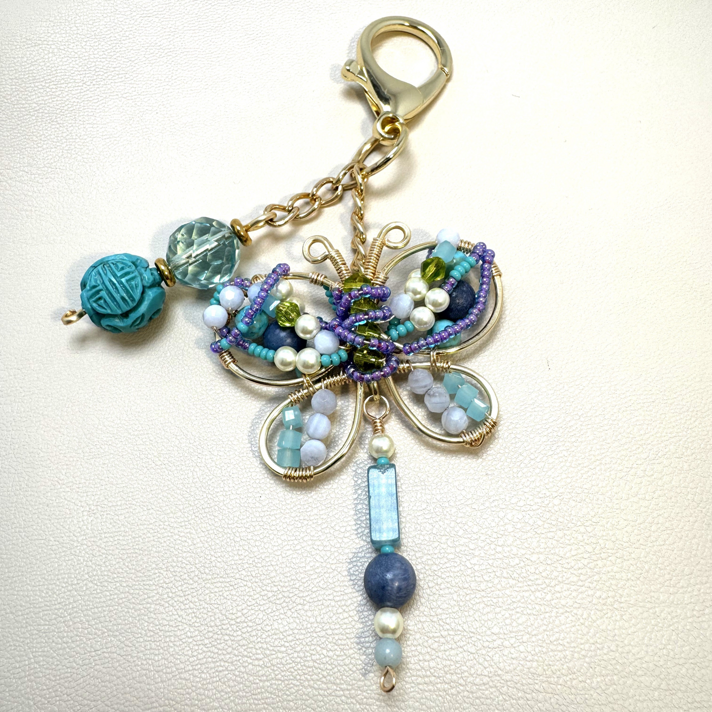 Handmade butterfly purse charm with semi-precious stones and wire wrapping, symbolizing transformation