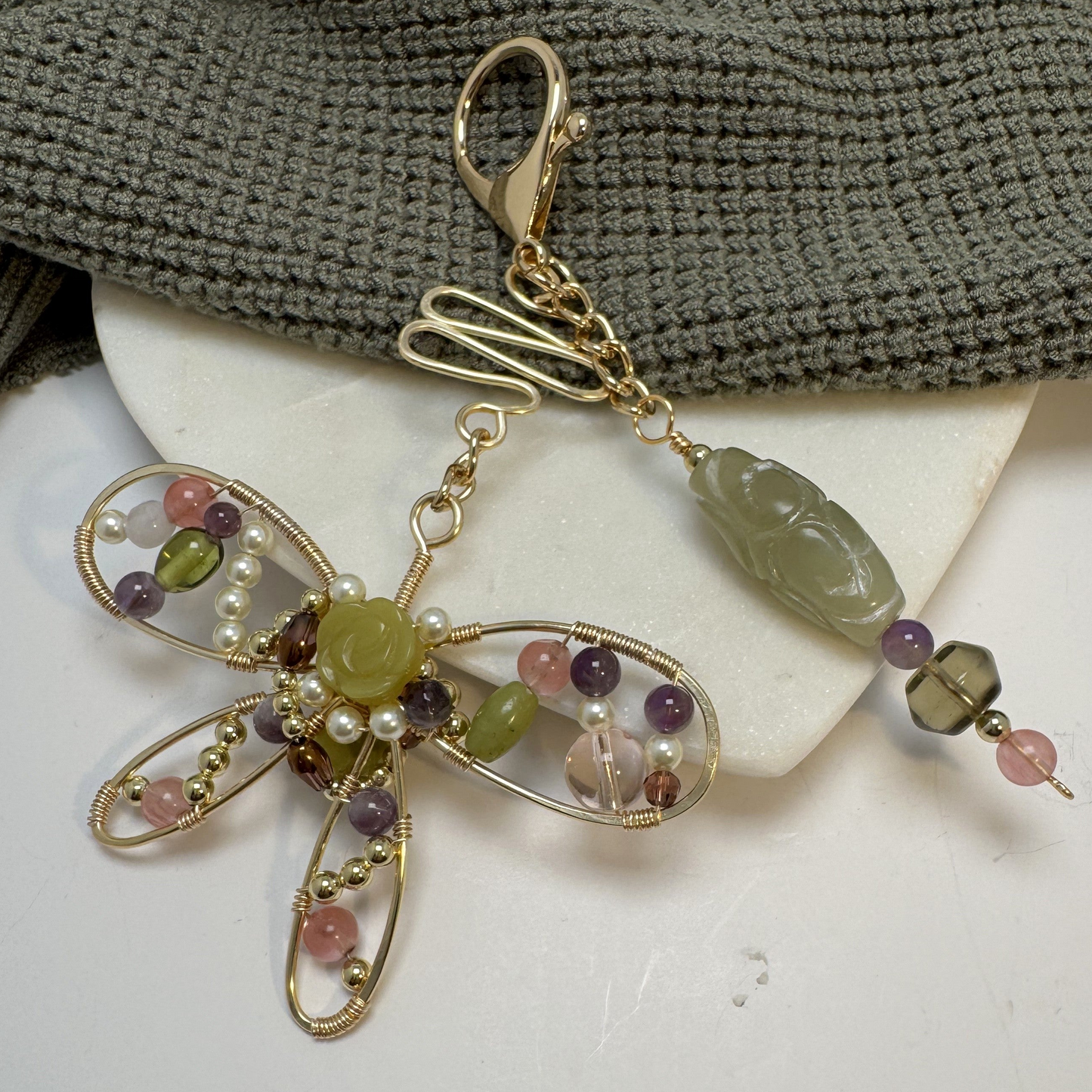Add meaning to your style with this handmade butterfly charm. Forged wire and gemstones celebrate new beginnings. Clips easily to any purse or tote.