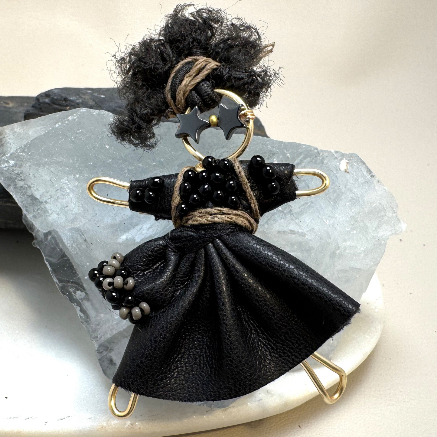 Close-up of handmade Rebel Pixie Pin with star sunglasses, faux leather, and handcrafted details.