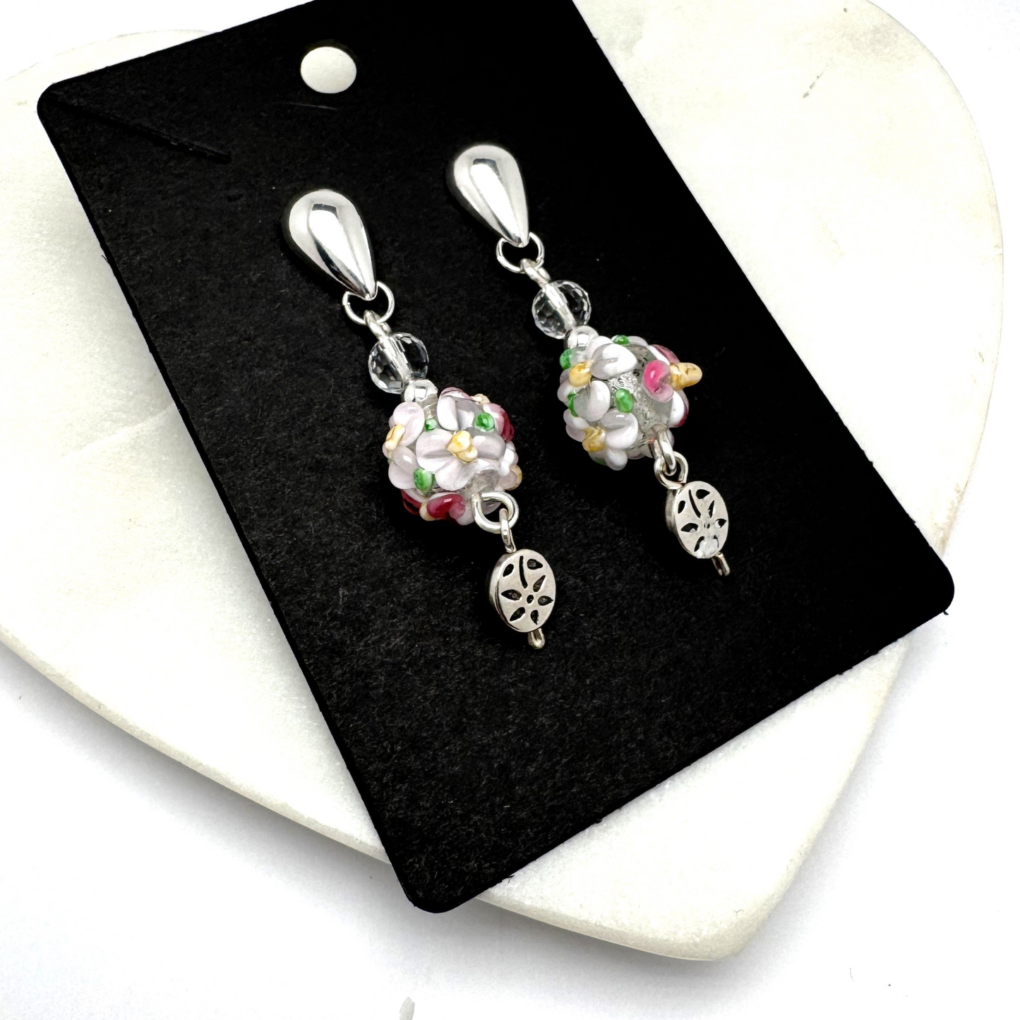 Delicate and feminine Blossom Dangle Earrings featuring intricately designed floral lamp work glass beads that exude charm and elegance