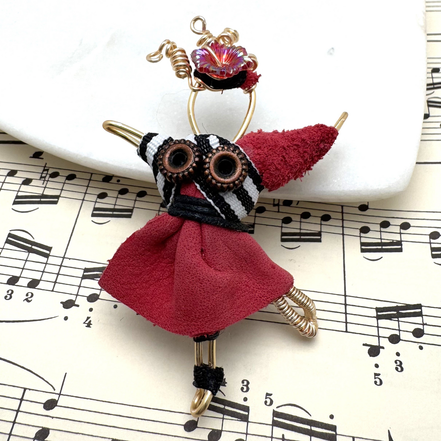 he Pixie Pin is a whimsical handmade brooch crafted from recycled silk, beads, ribbon, and wire, inspired by the playful spirit of pixies. Perfect for adding a touch of enchantment to jackets, scarves, or bags.