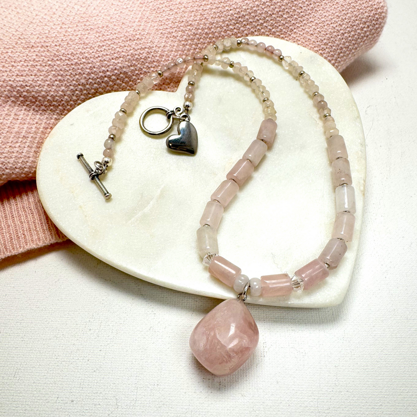 A delicate handmade rose quartz Y-necklace with silver accents, designed for layering or wearing alone. Featuring the "Love Stone," rose quartz is believed to open the heart to love and healing. Handmade in Canada.
