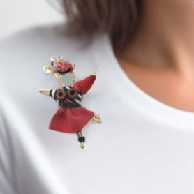 he Pixie Pin is a whimsical handmade brooch crafted from recycled silk, beads, ribbon, and wire, inspired by the playful spirit of pixies. Perfect for adding a touch of enchantment to jackets, scarves, or bags.