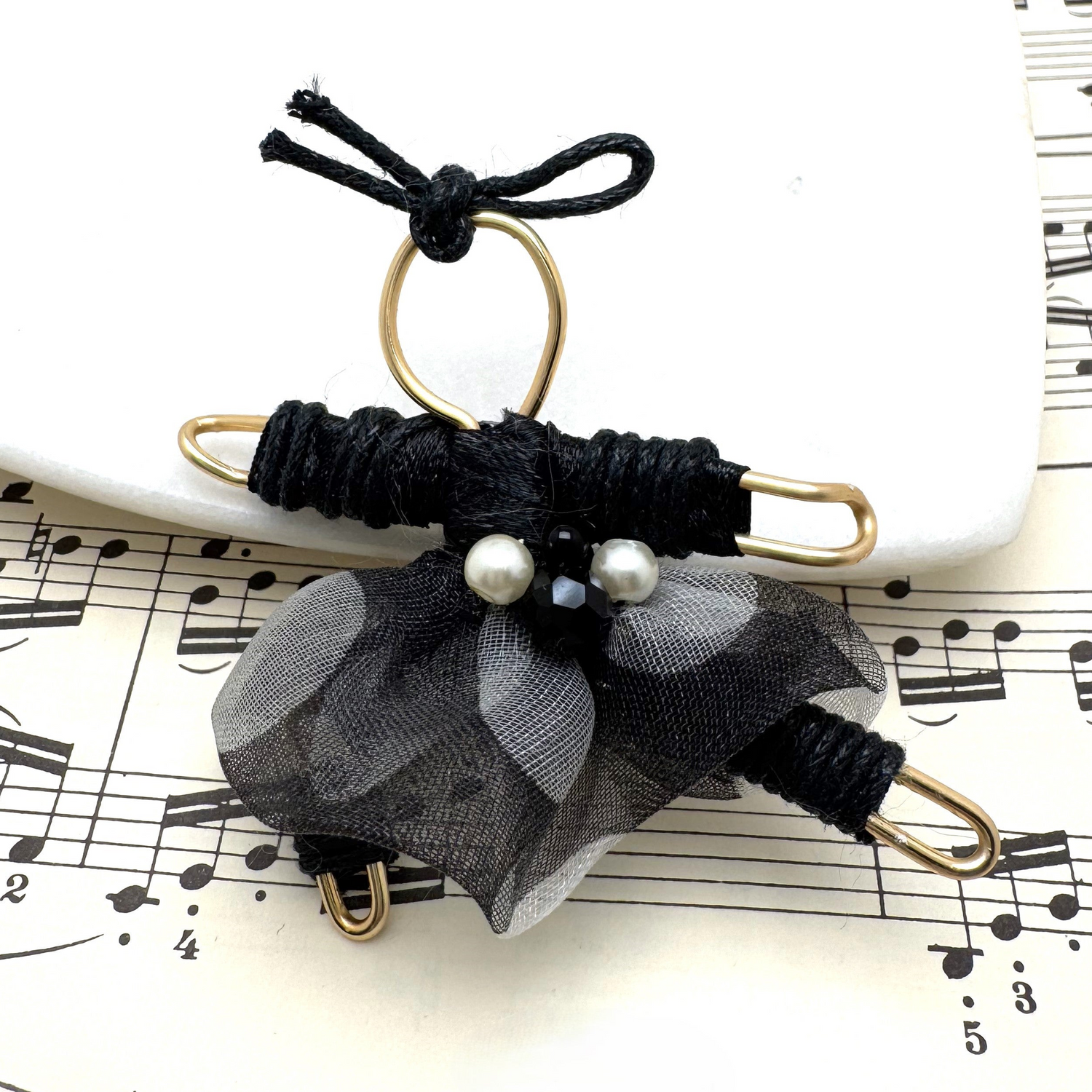 A handcrafted Pixie Pin brooch featuring delicate details, recycled materials, and natural stones, designed to capture the playful and enchanting spirit of the pixie realm. Made in Canada.