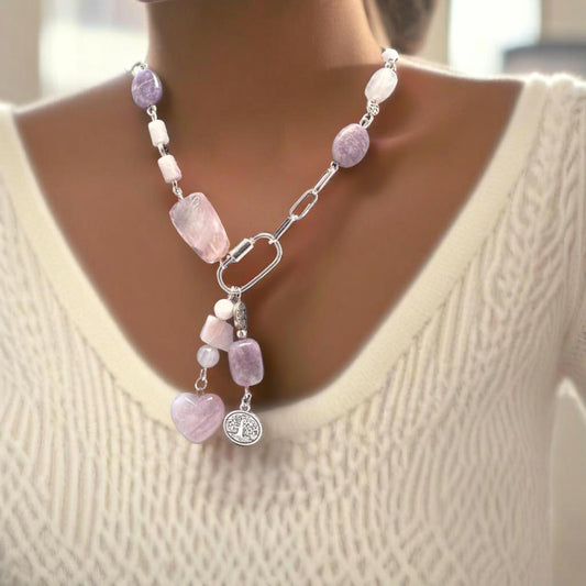 Bold 18-inch silver necklace featuring rose quartz, amethyst, and pink opal stones in an asymmetrical design. Dangled charms include a rose quartz heart with pink opal and an amethyst paired with a Tree of Life charm. A timeless, modern accessory perfect for day-to-night wear.