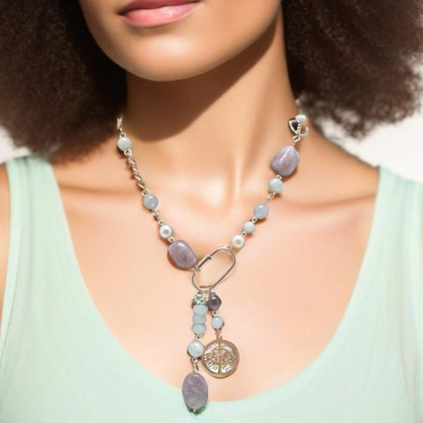 Bold 18-inch necklace featuring aquamarine, amethyst, and quartz stones on a gold chain. Highlighted with a gold carabiner, Tree of Life charm, and polished amethyst stone. Finished with a handcrafted hook clasp for an edgy, sophisticated design.