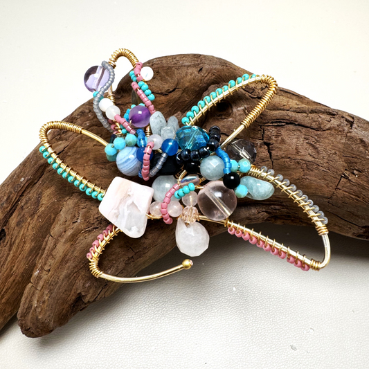 Multicolored beaded flower accessory on a piece of driftwood