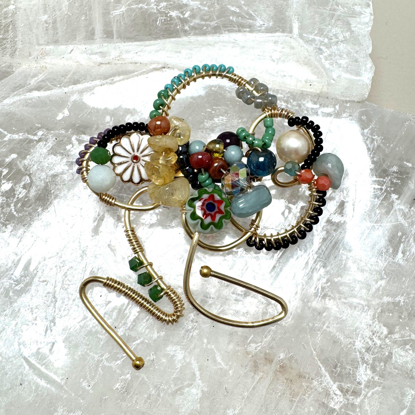 Decorative brooch with beads on a textured white surface