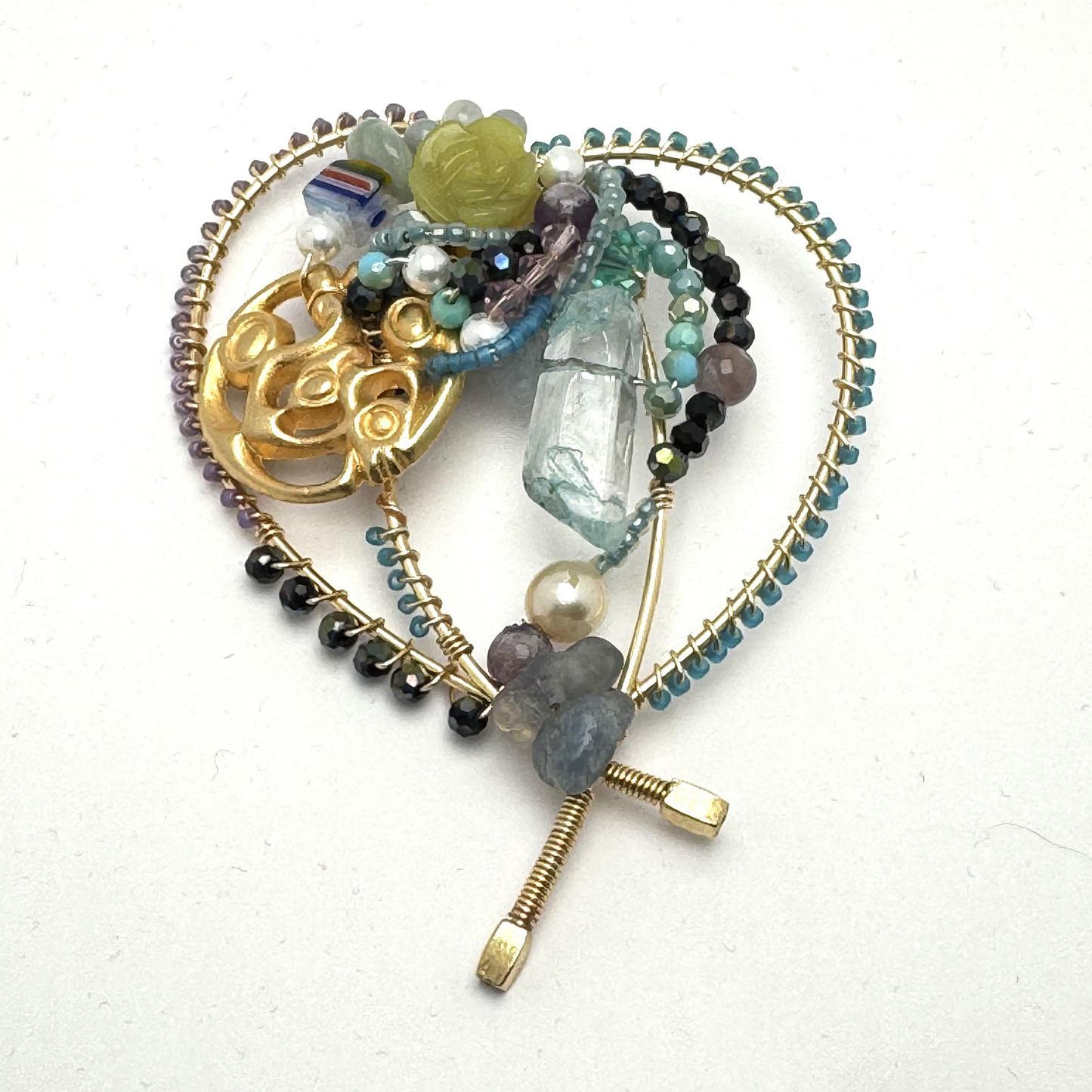 Wire handmade brooch with beadwork and found accents.