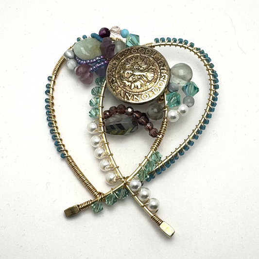 beaded wire forged brooch in sea green tones with military vintage accent.