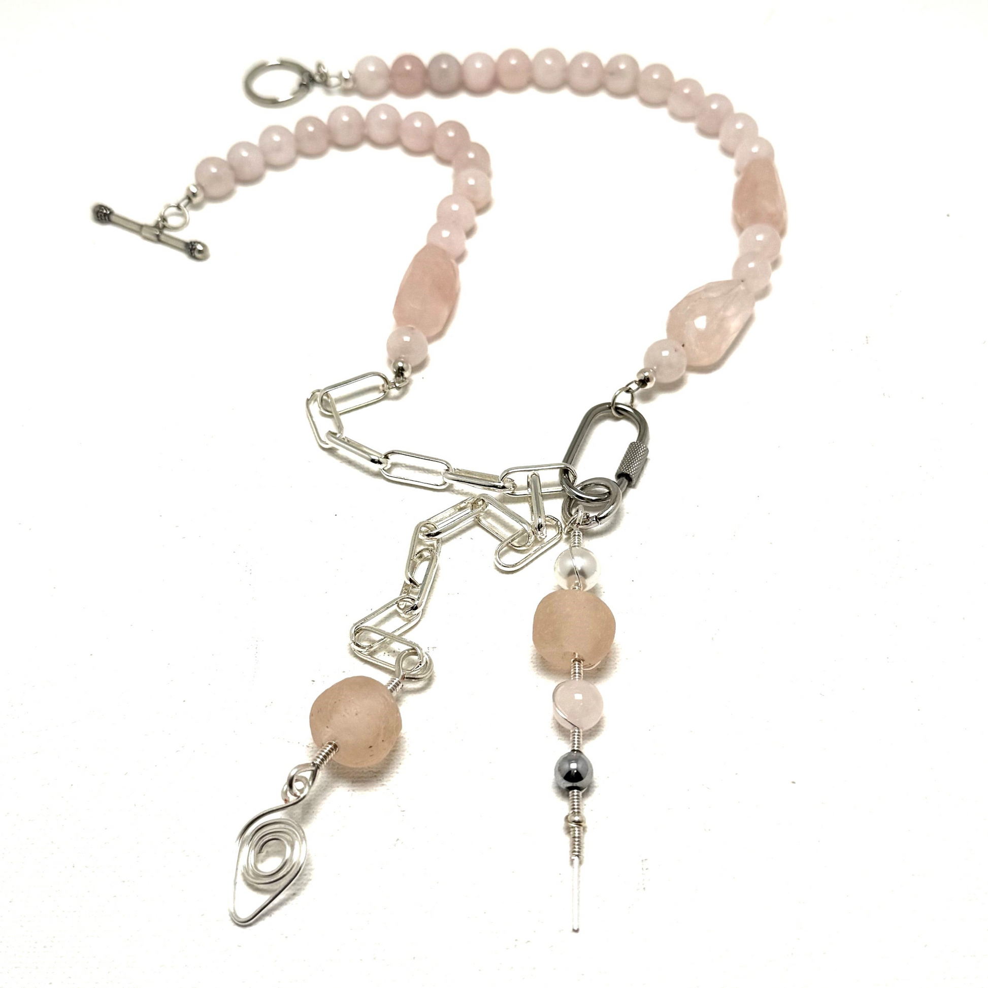 A handcrafted layering necklace featuring rose quartz and pink sea glass, designed for versatility and elegance. Known as the stone of love, rose quartz promotes healing and balance. Adjustable, with an 18-inch (46 cm) neck length and a 6-inch (15 cm) pendant drop. Handmade in Canada.