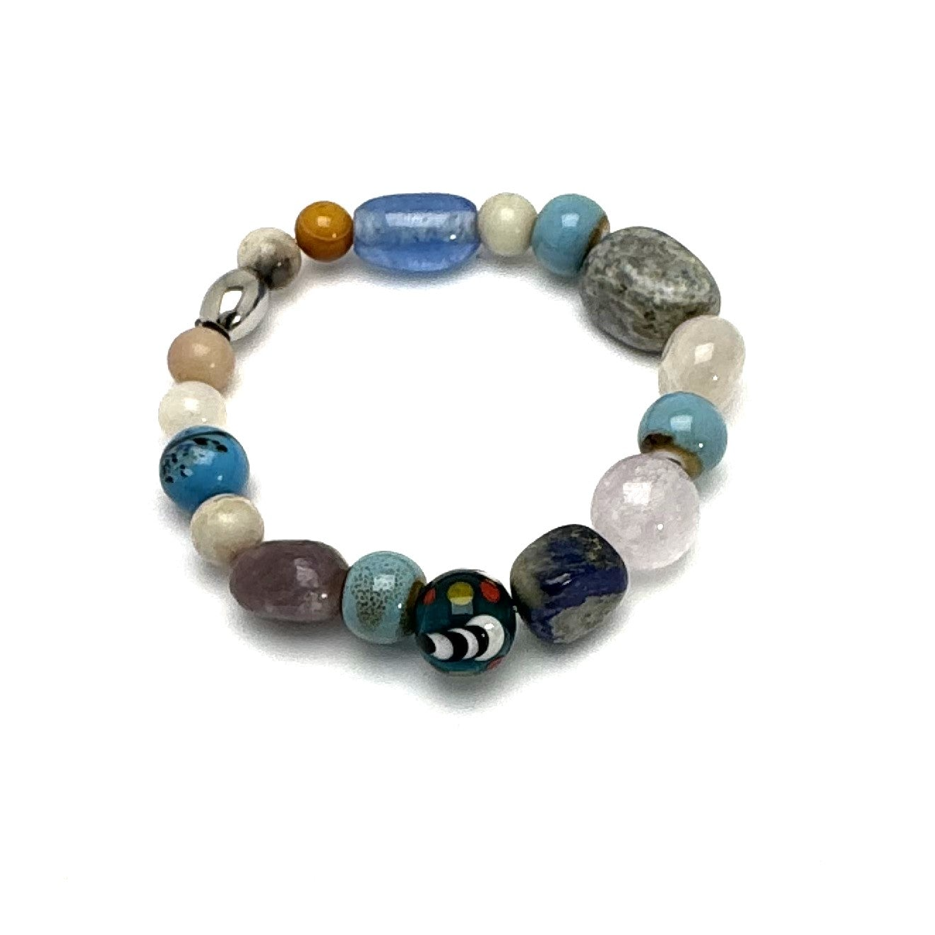 A multicolored beaded bracelet with a mix of angelite, aventurine, and ceramic vintage beads, featuring a lotus flower charm.