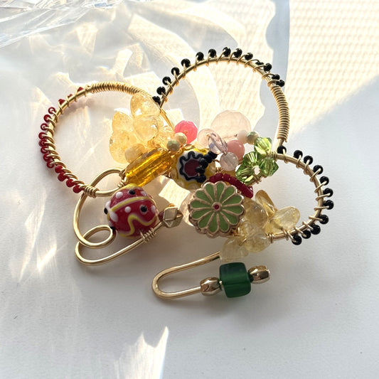 Decorative brooch with colorful beads on a white background