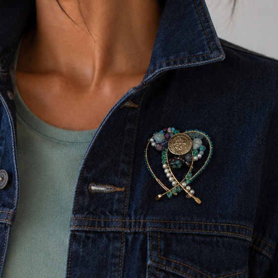 Wire beaded brooch on a dark jean jacket