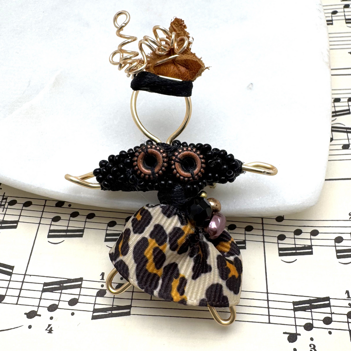 he Pixie Pin is a whimsical handmade brooch crafted from recycled silk, beads, ribbon, and wire, inspired by the playful spirit of pixies. Perfect for adding a touch of enchantment to jackets, scarves, or bags.