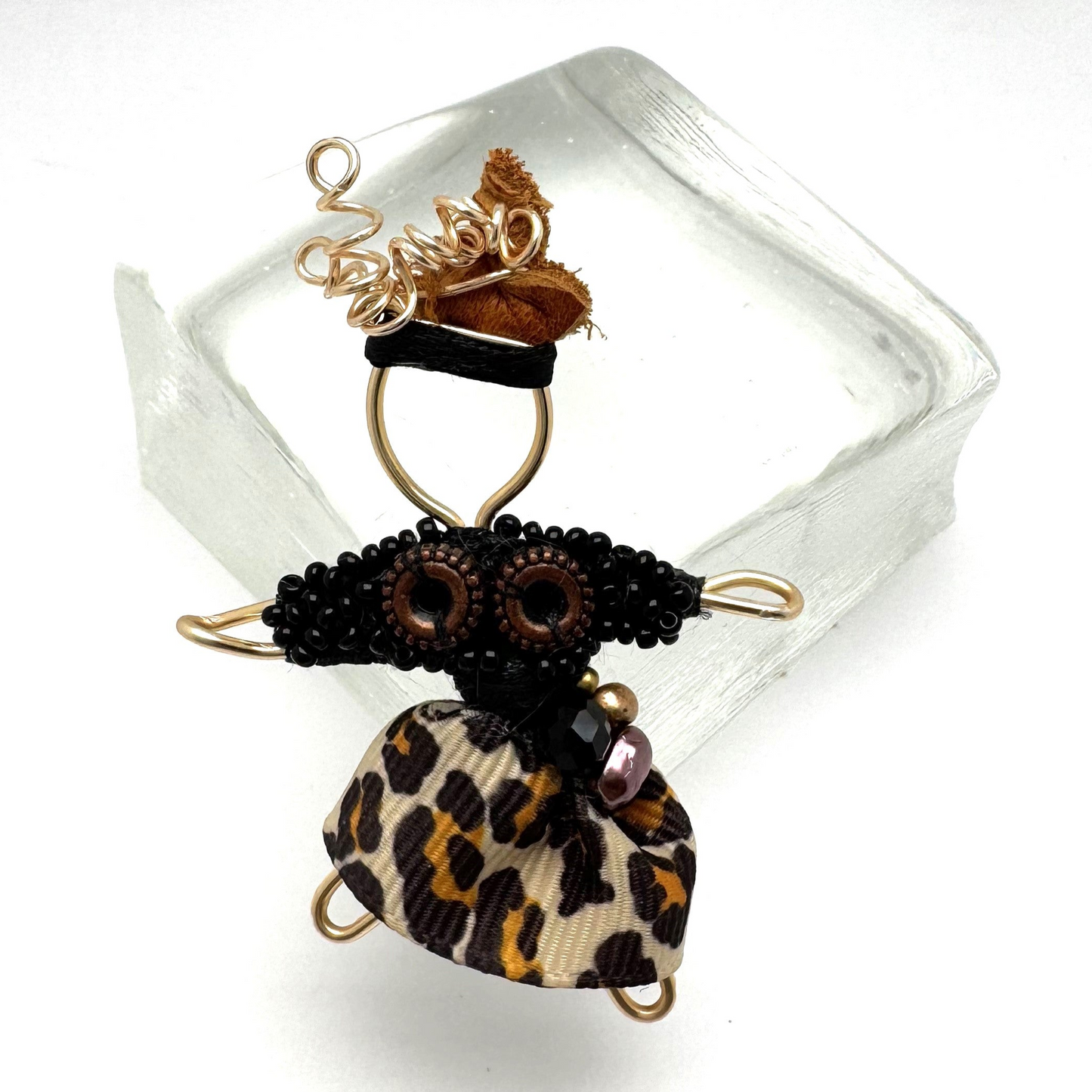 he Pixie Pin is a whimsical handmade brooch crafted from recycled silk, beads, ribbon, and wire, inspired by the playful spirit of pixies. Perfect for adding a touch of enchantment to jackets, scarves, or bags.