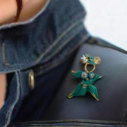 A handcrafted Pixie Pin brooch made from soft turquoise suede, featuring a whimsical design that embodies creativity and nature-inspired charm. Made in Canada with recycled materials.